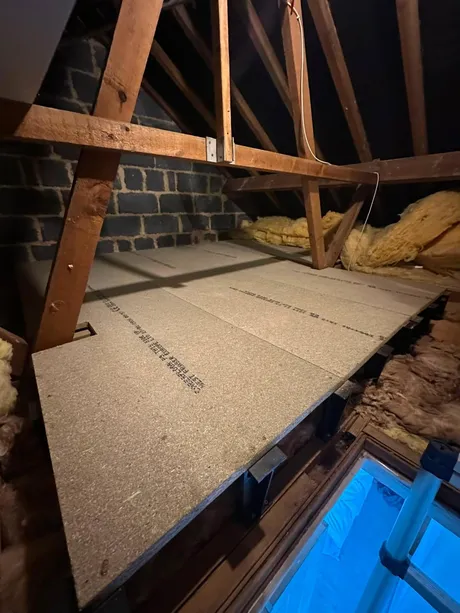 A loft boarded out on raised legs over new insulation.