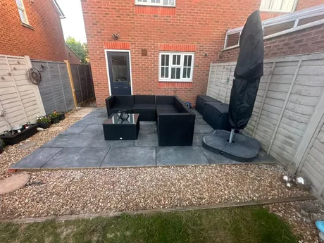 Old decking removed and a patio laid in its place.